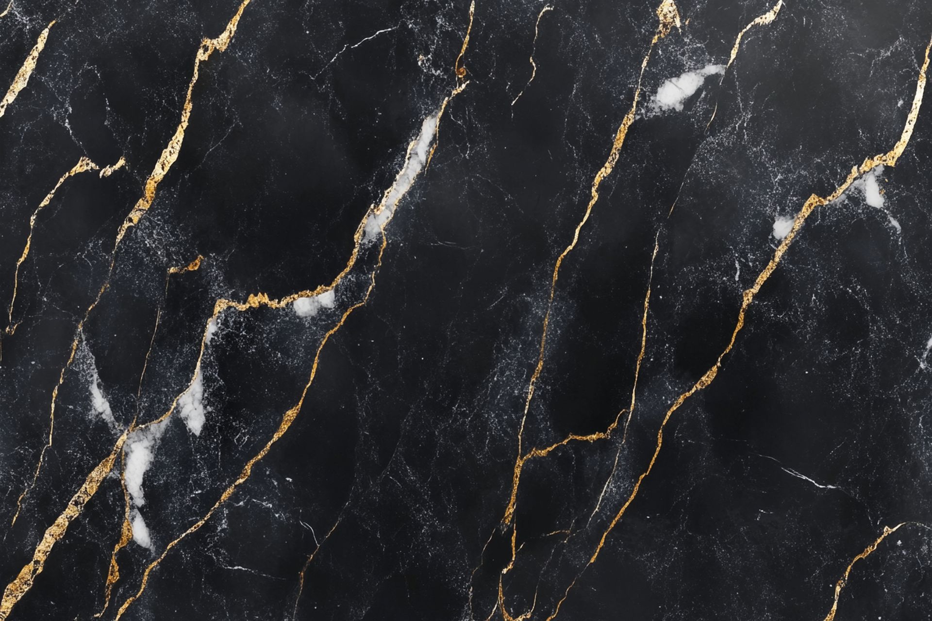 A close up of a black marble counter top with gold veins.