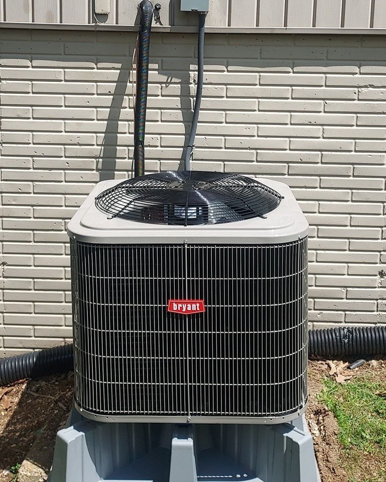 A man is working on a ventilation system in a building.