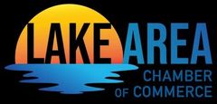 Lake Area Chamber of Commerce logo with orange sunset, blue water, and black and blue text