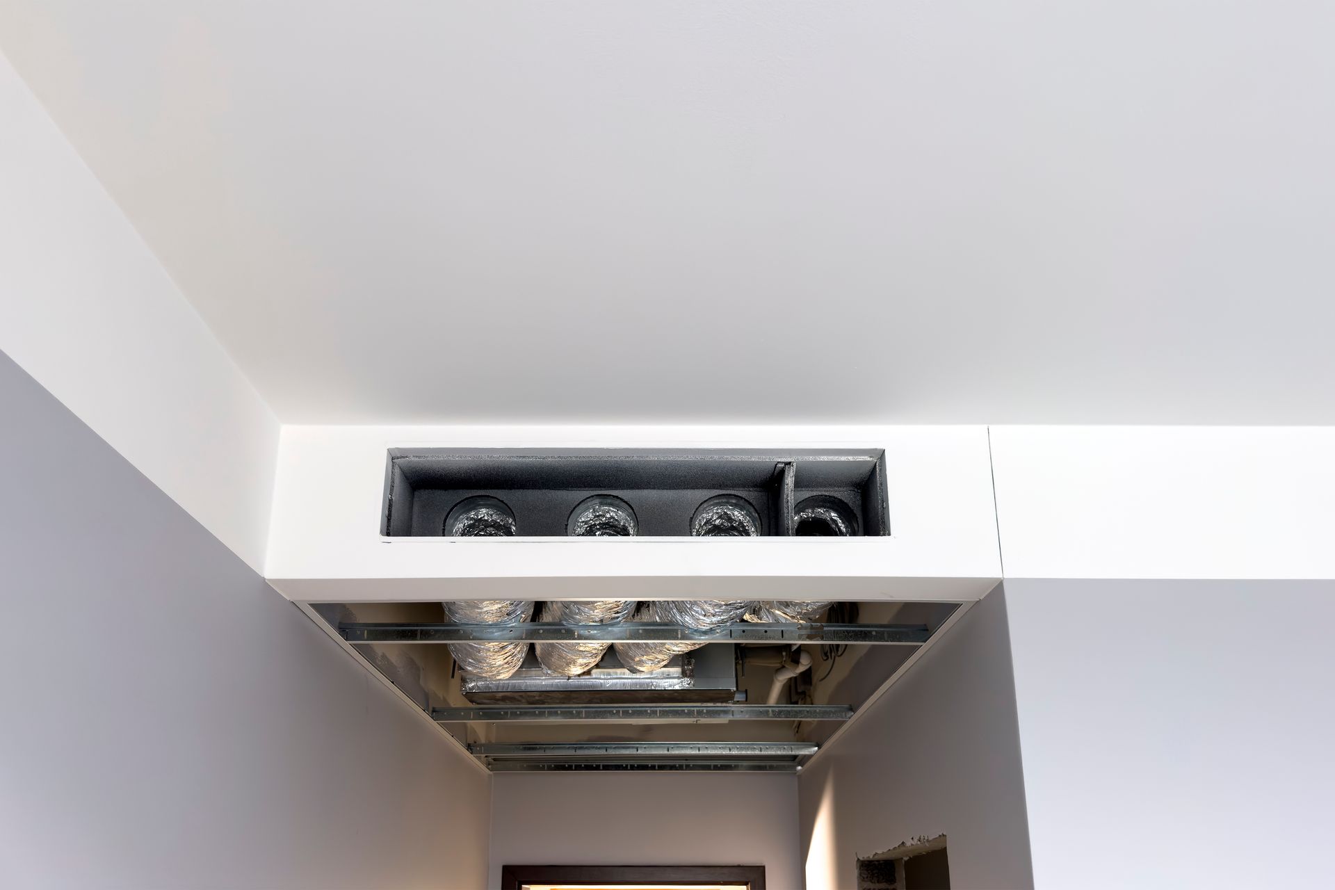 A hallway with a ceiling fan in the middle of it.