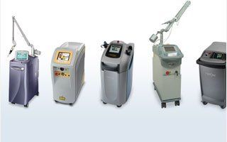 a group of laser hair removal machines are lined up in a row on a white background .