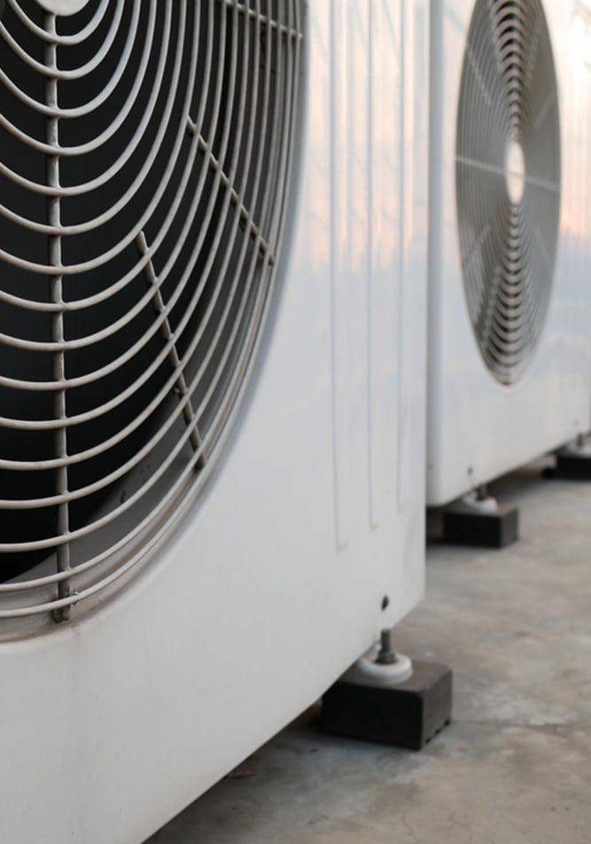 An Air Conditioner Is Sitting on The Side of A House — Allchin Airconditioning & Refrigeration Electrical In Caloundra, QLD