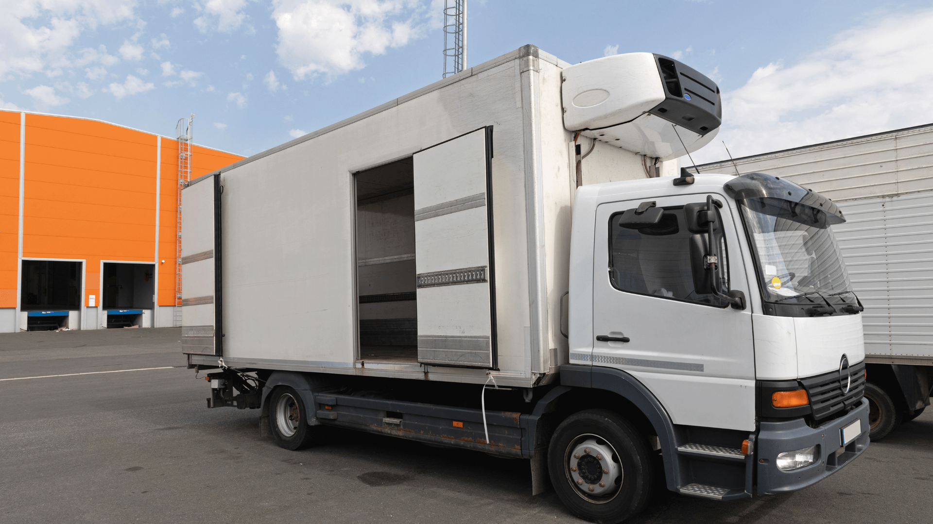 White refrigerated delivery truck with open side door parked outdoors — Allchin Airconditioning & Refrigeration Electrical in Caloundra, QLD
