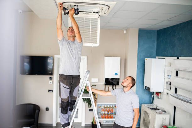 Two Men Installing or Repairing Ceiling Air Conditioning Unit — Allchin Airconditioning & Refrigeration Electrical in Caloundra, QLD