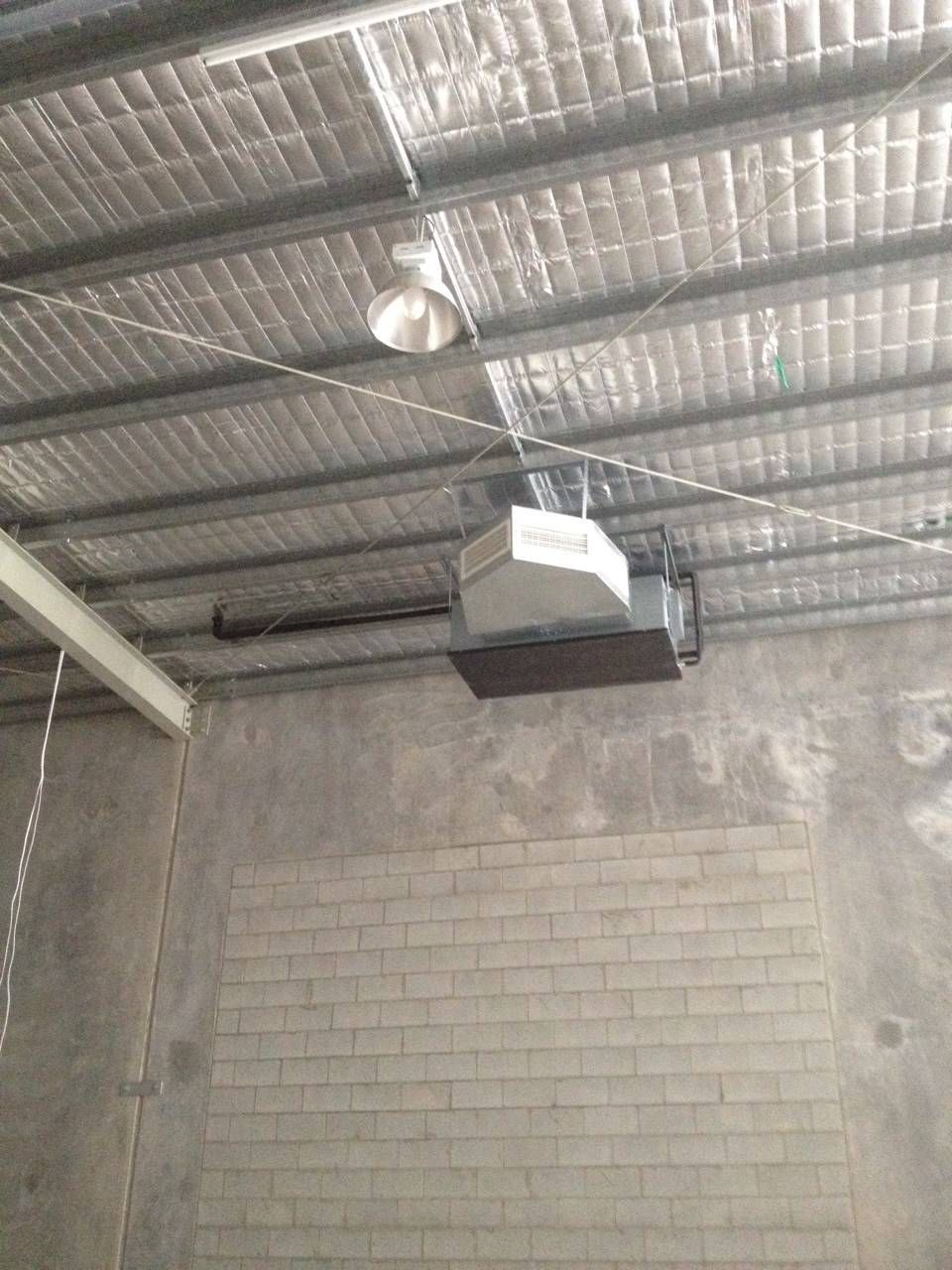 Industrial Ceiling with Light Fixture, Heater, and Brick Wall — Allchin Airconditioning & Refrigeration Electrical in Caloundra, QLD