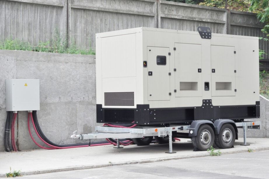 Generator on A Trailer Beside a Wall, Connected to A Box — Allchin Airconditioning & Refrigeration Electrical in Caloundra, QLD