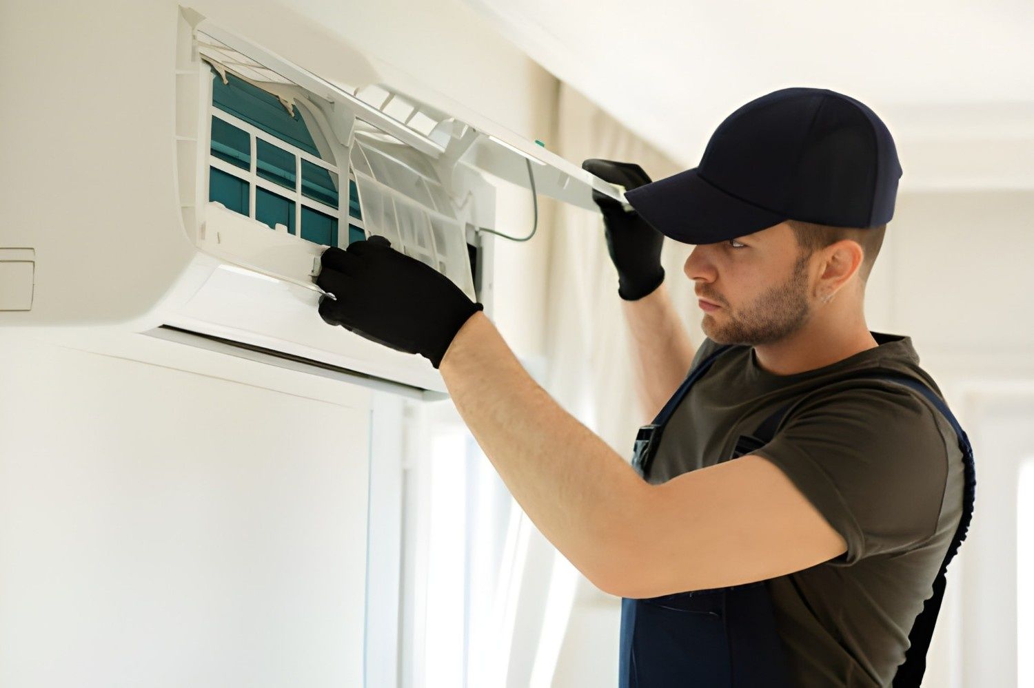 A Man Removing Air Filter from A Wall — Allchin Airconditioning & Refrigeration Electrical in Caloundra, QLD