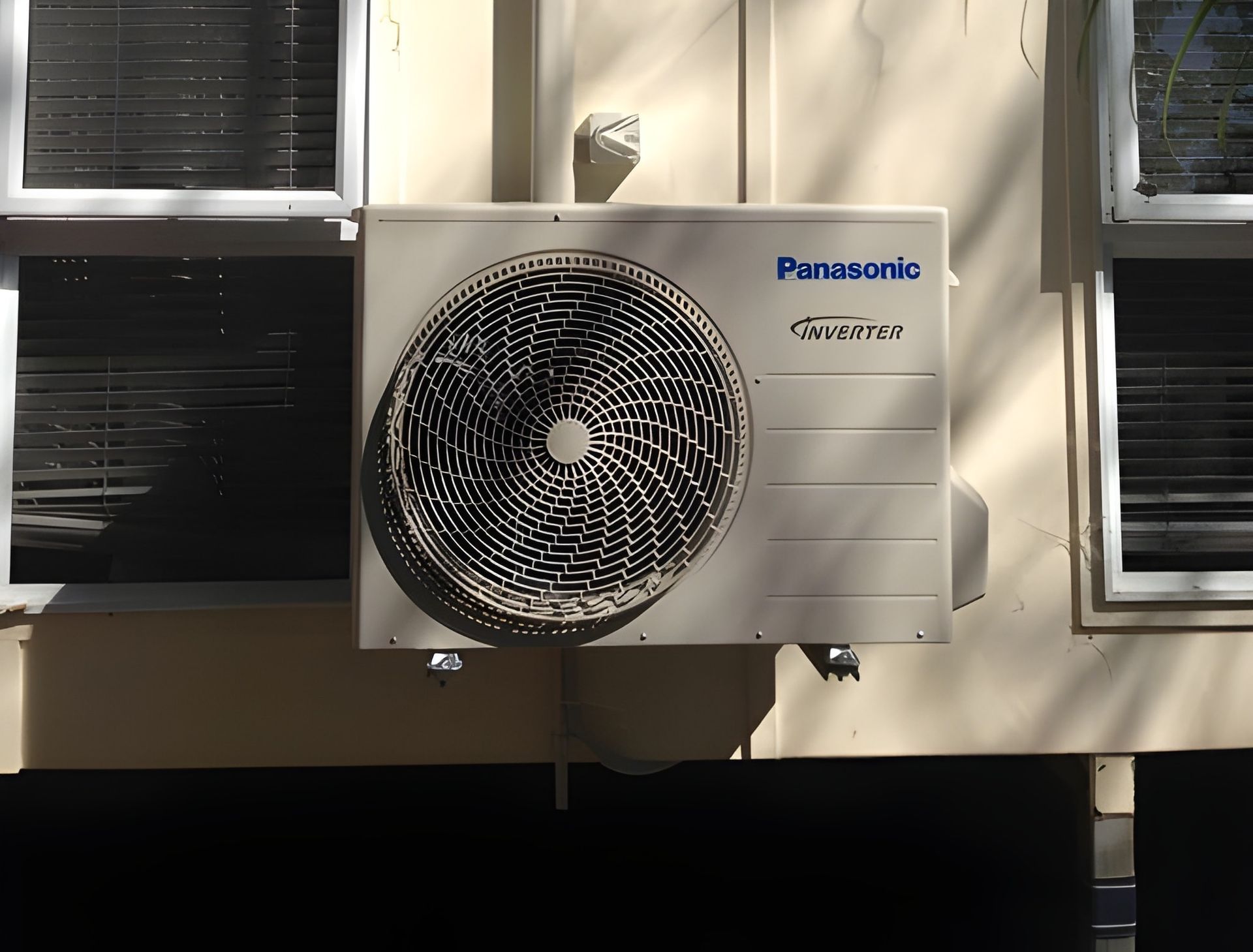 Panasonic Air Conditioning Unit on A Wall Next to Windows — Allchin Airconditioning & Refrigeration Electrical in Caloundra, QLD
