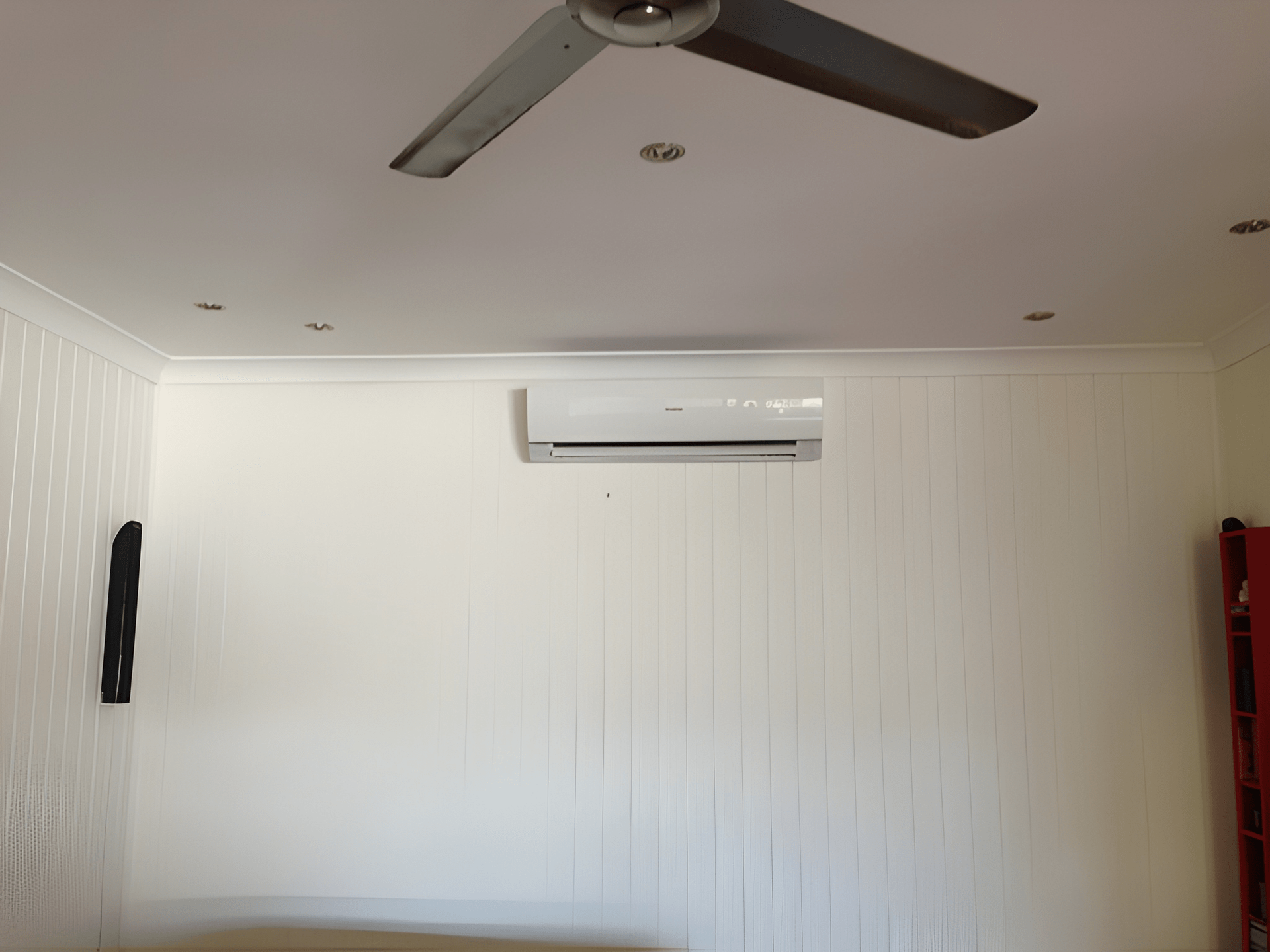 White Paneled Wall with Air Conditioner — Allchin Airconditioning & Refrigeration Electrical in Caloundra, QLD