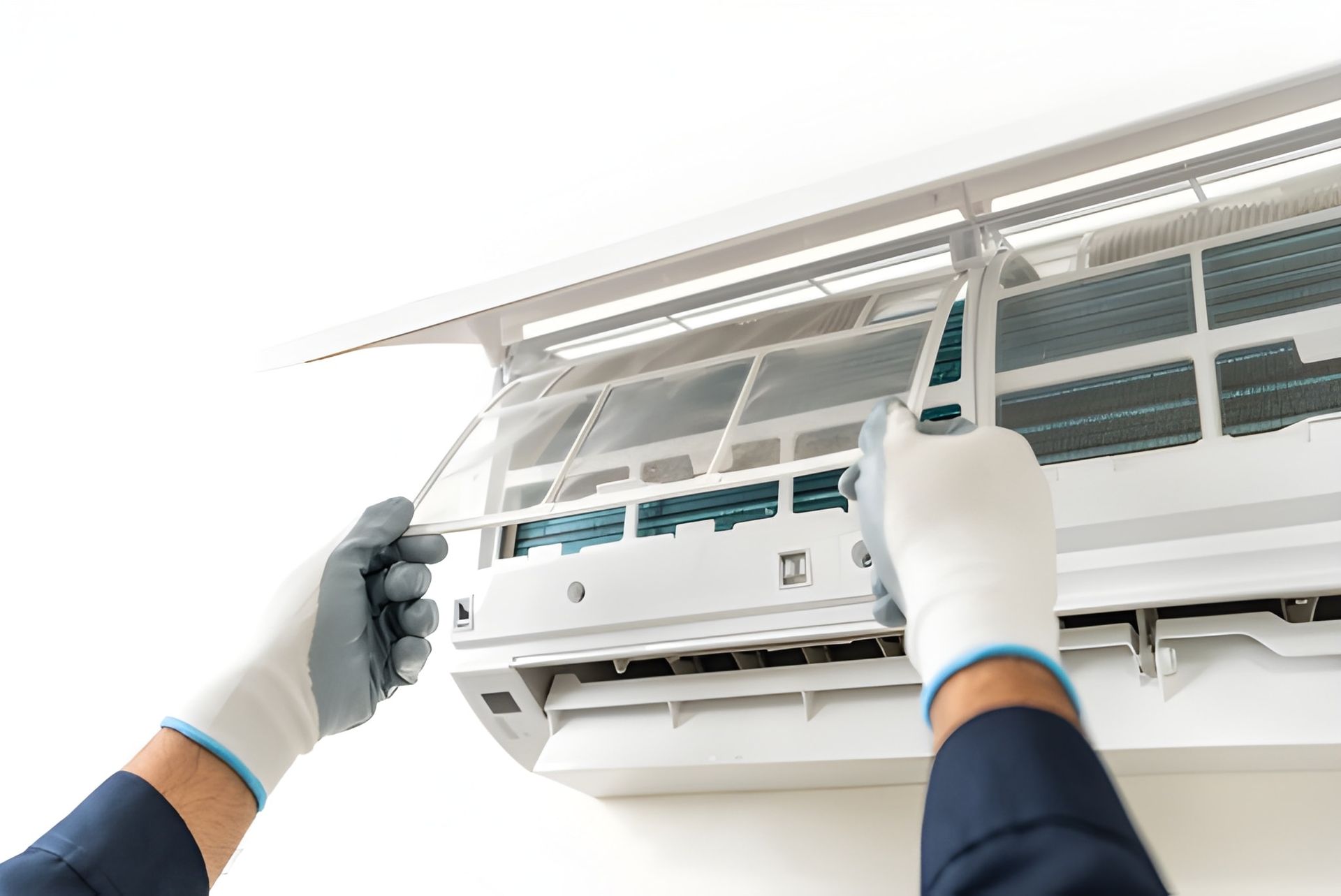 A Person Is Removing an Air Conditioner Filter for Cleaning — Allchin Airconditioning & Refrigeration Electrical in Caloundra, QLD