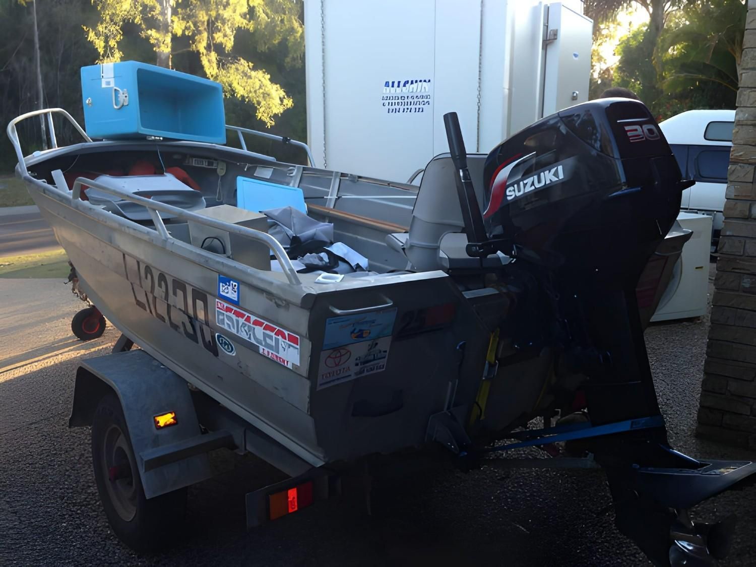 An Aluminum Boat on A Trailer with A Suzuki Outboard Motor — Allchin Airconditioning & Refrigeration Electrical In Caloundra, QLD