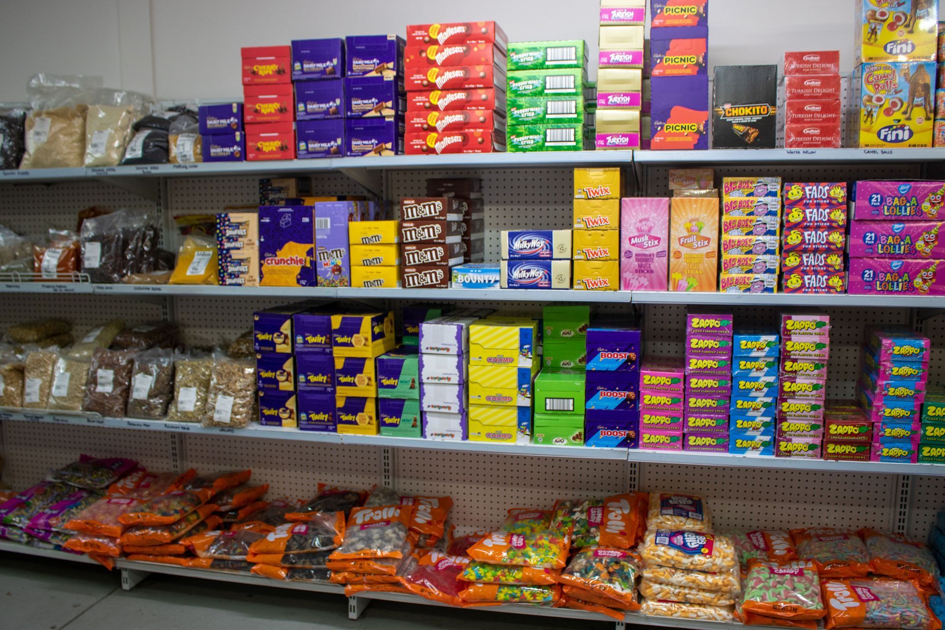 Variety Of Chocolates On A Table With A Spoon  — Quality Wholesale Confectionery in Ballarat, VIC