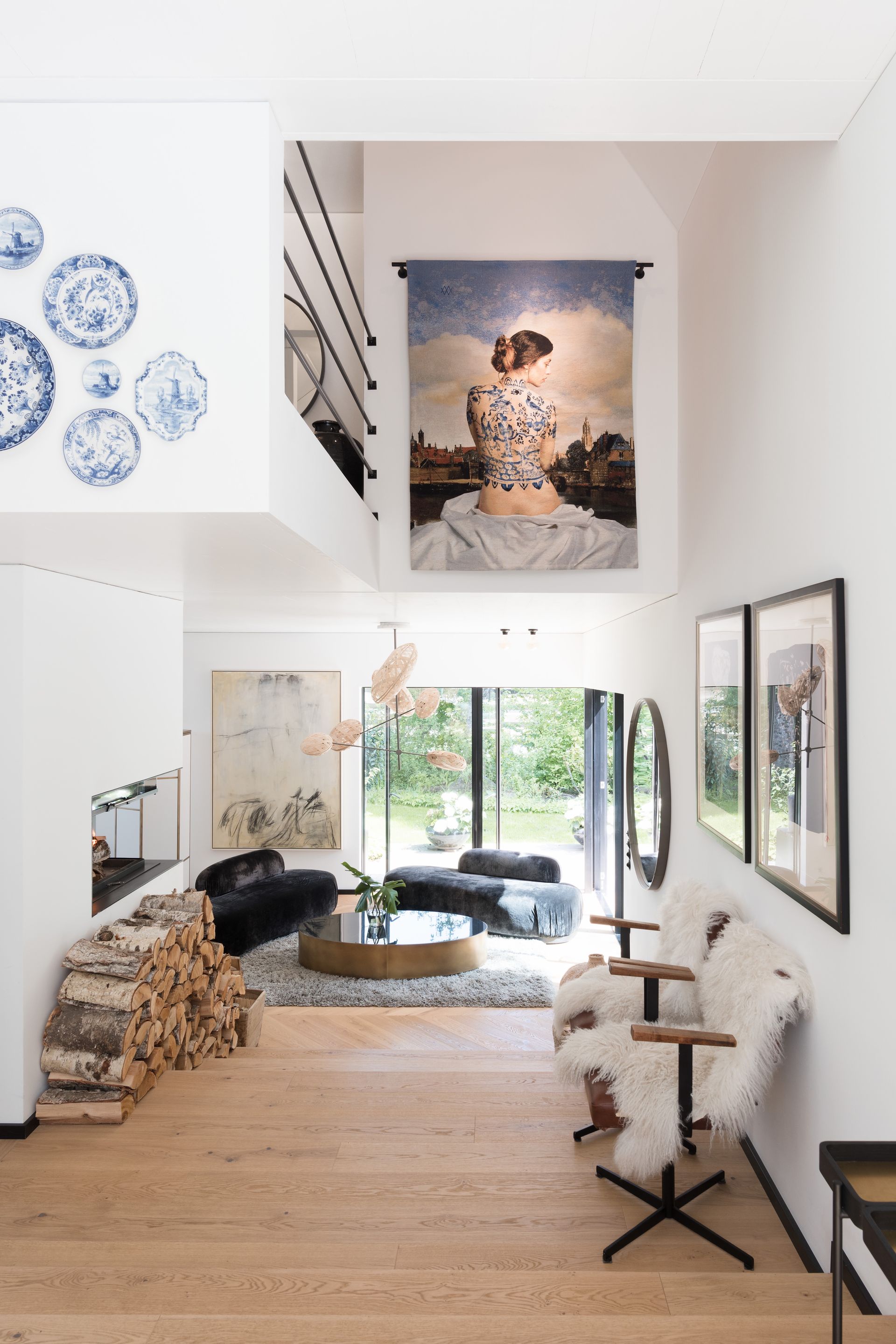 Modern home interior with high ceilings, art, and natural light.