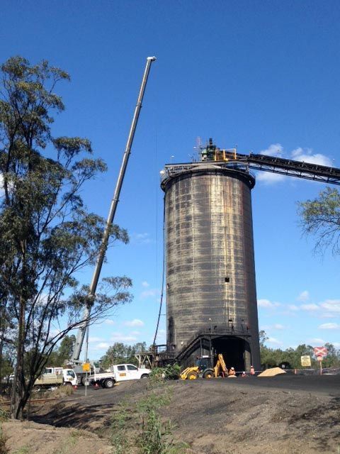 A Large Silo Is Being Lifted By A Crane — S & W Crane Hire In Whitsundays, QLD