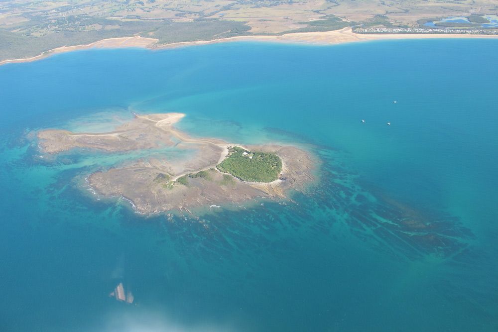 An Aerial View Of A Small Island In The Middle Of A Large Body Of Water — S & W Crane Hire In Collinsville, QLD