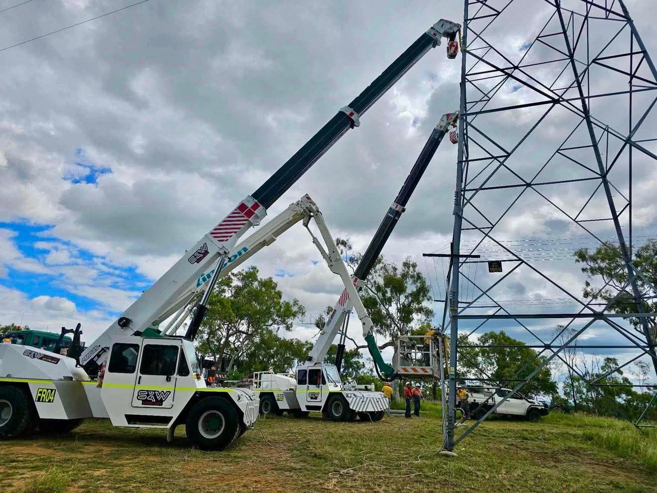 A group of cranes are working on a power tower — S & W Crane Hire In Bowen, QLD