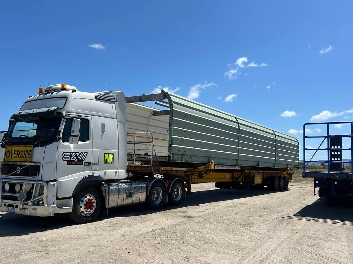 A large semi truck is parked in a dirt lot — S & W Crane Hire In Bowen, QLD