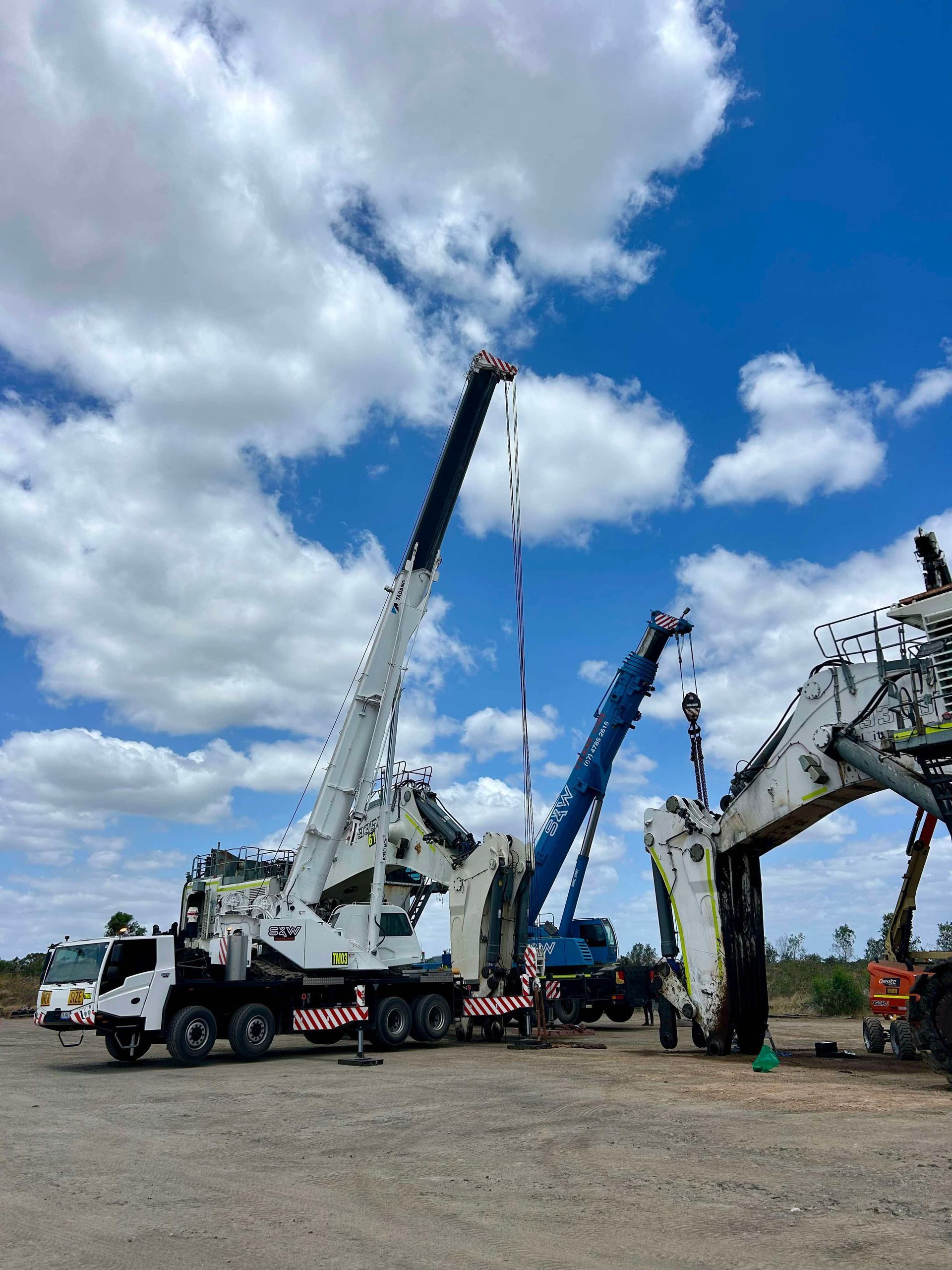 A truck with a crane attached to it is parked in a parking lot — S & W Crane Hire In Bowen, QLD