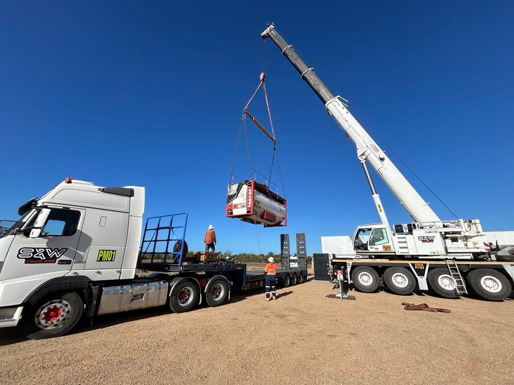 A large truck is being lifted by a large crane - — S & W Crane Hire In Bowen, QLD