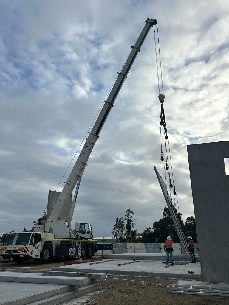 A large crane is working on a construction site — S & W Crane Hire In Collinsville, QLD