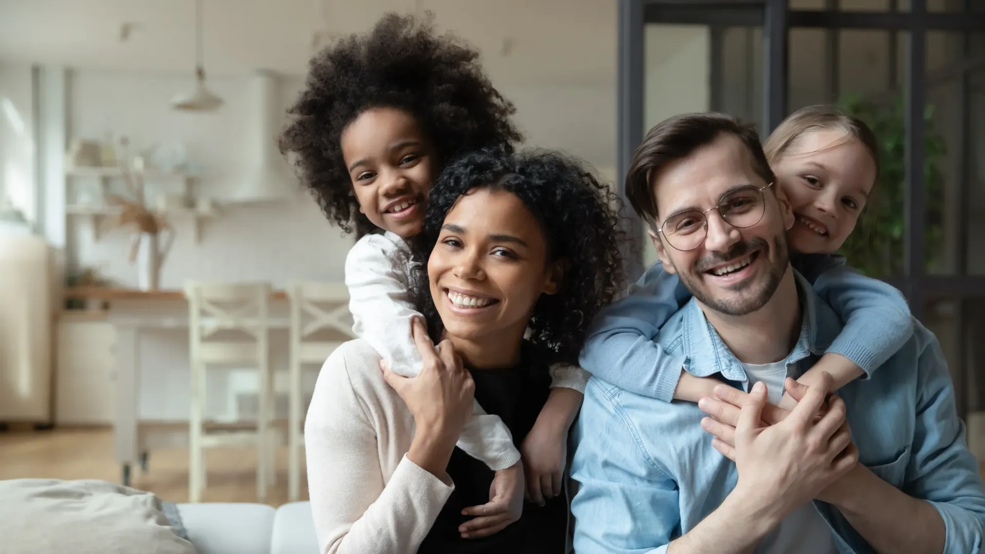A family is posing for a picture while sitting on a couch.