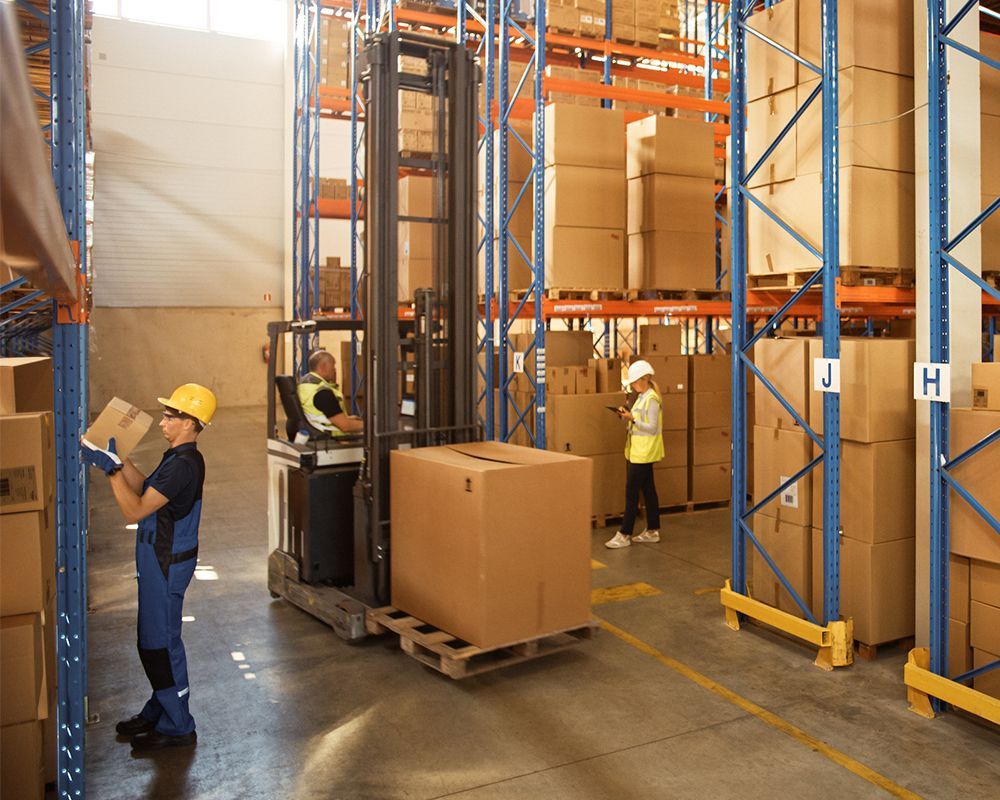 Warehouse workers move inventory with forklifts, placed with safety striping by Warehouse Equipment Solutions in Desoto, TX.