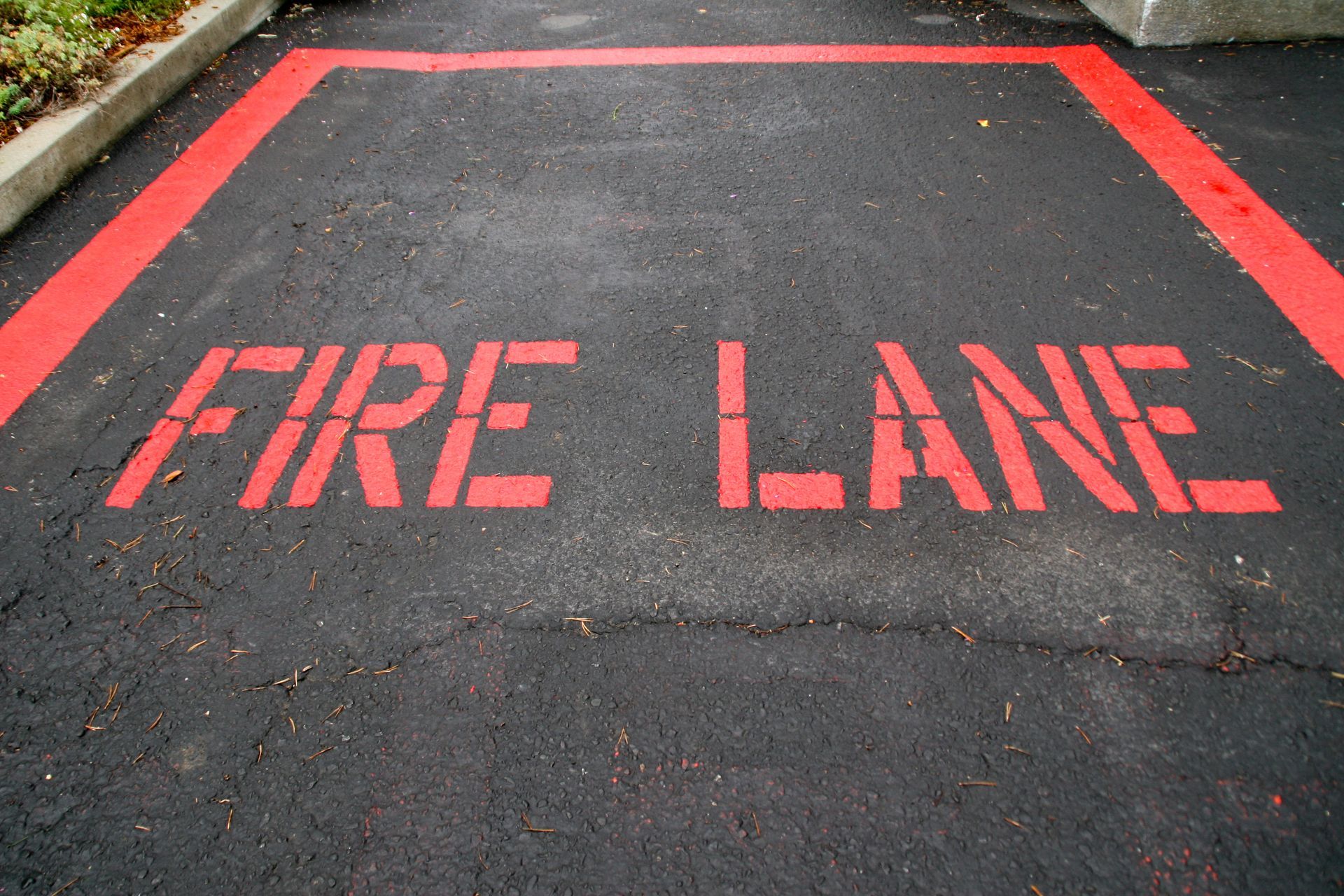 Fire Lane painted on parking lot black top. Fire Lane painted on parking lot black top.