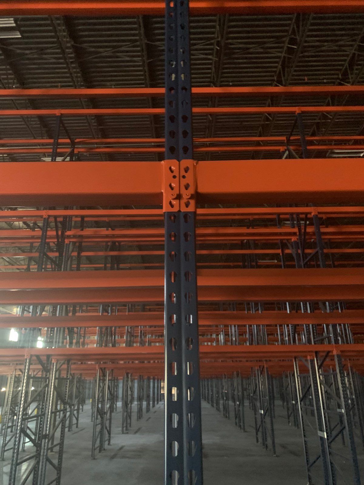 A warehouse filled with lots of shelves and a ceiling.