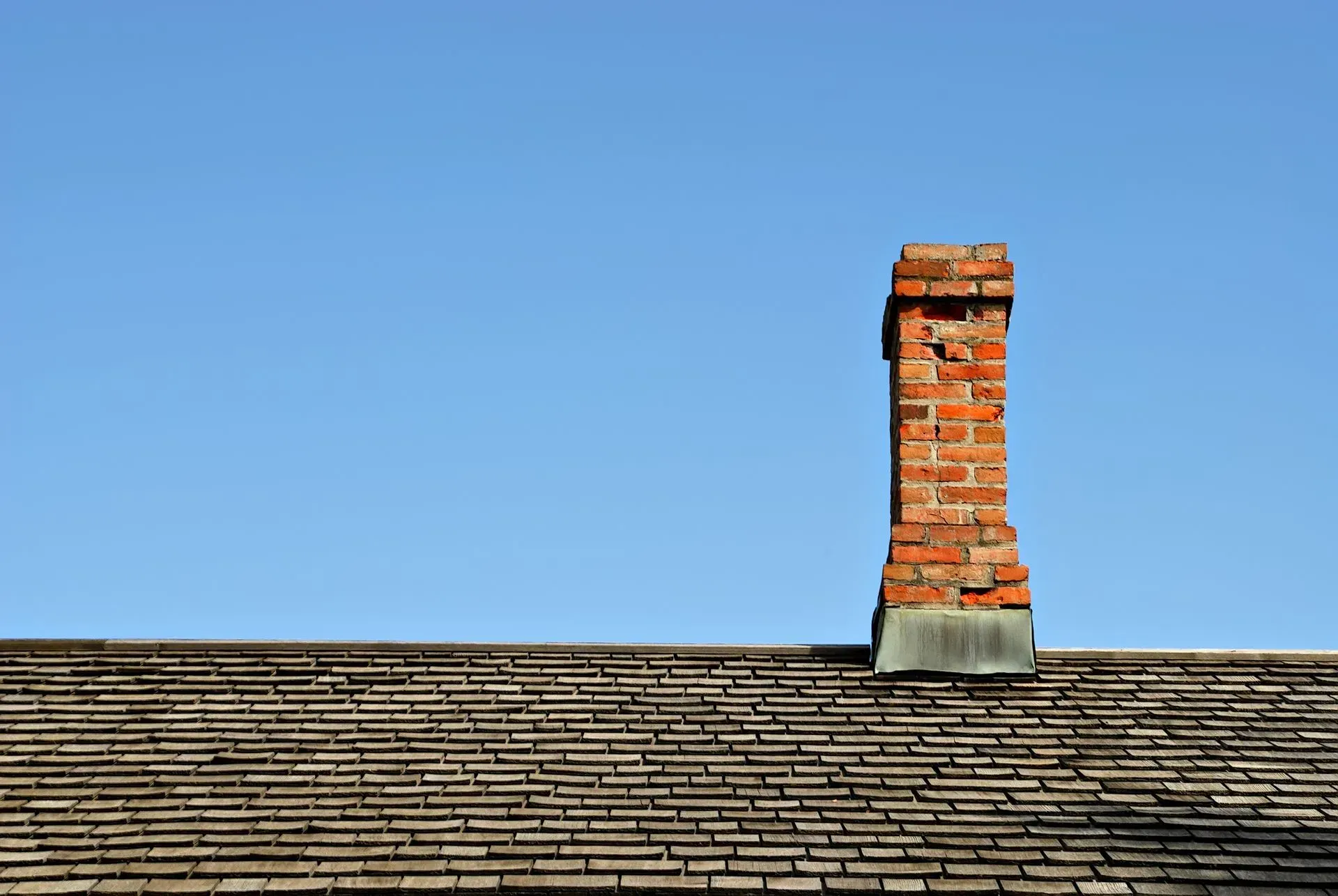 A damaged chimney can have serious consequences for your roof and overall home integrity.