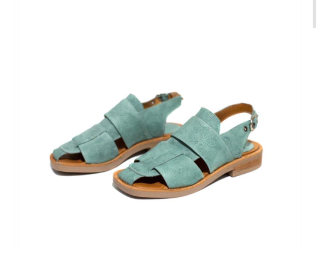 Sandalias de piel azul con suela marrón.