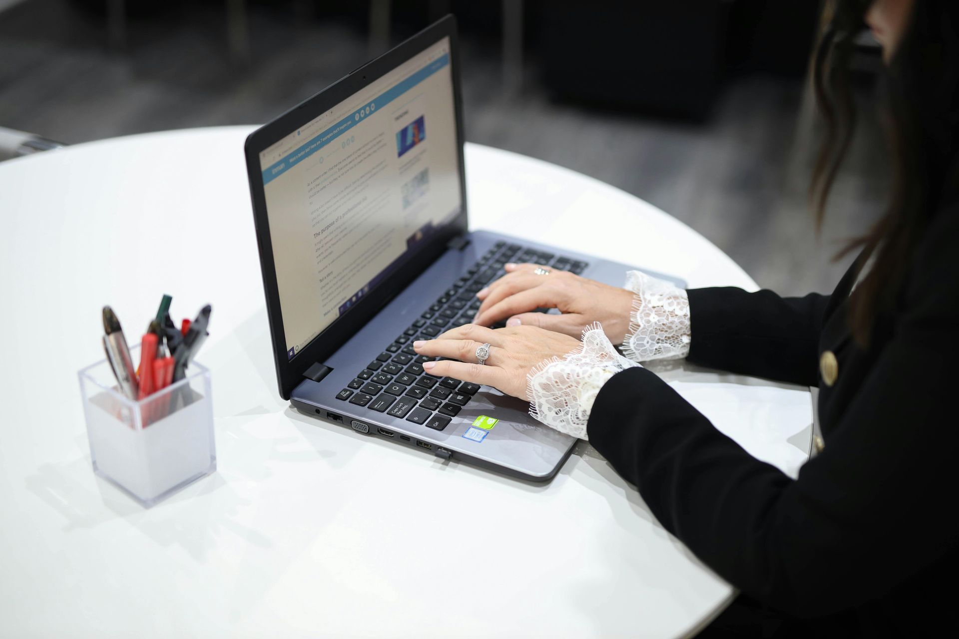 A man is sitting at a desk in front of three computer monitors.