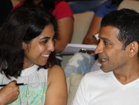 Engaged discussion between spouses during advanced couples coaching in Pune workshop
