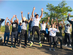 Participants leaping during an energizer session guided by a business coach in Pune to build team spirit.