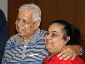 Mature pair smiling arm-in-arm at the Pune family segment of couples coaching
