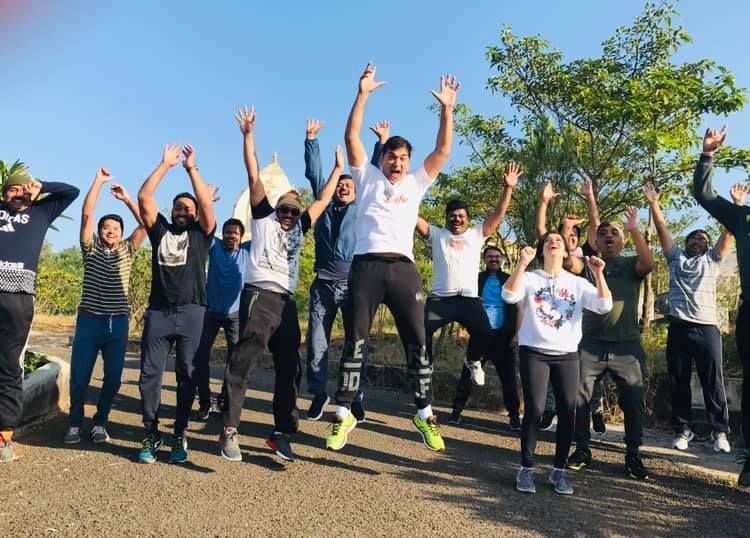 High-energy jump shot of participants celebrating new consulting business ideas learned in Pune.