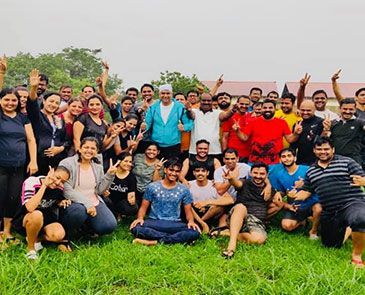 Large group photo of entrepreneurs and mentors bonding during an outdoor retreat.