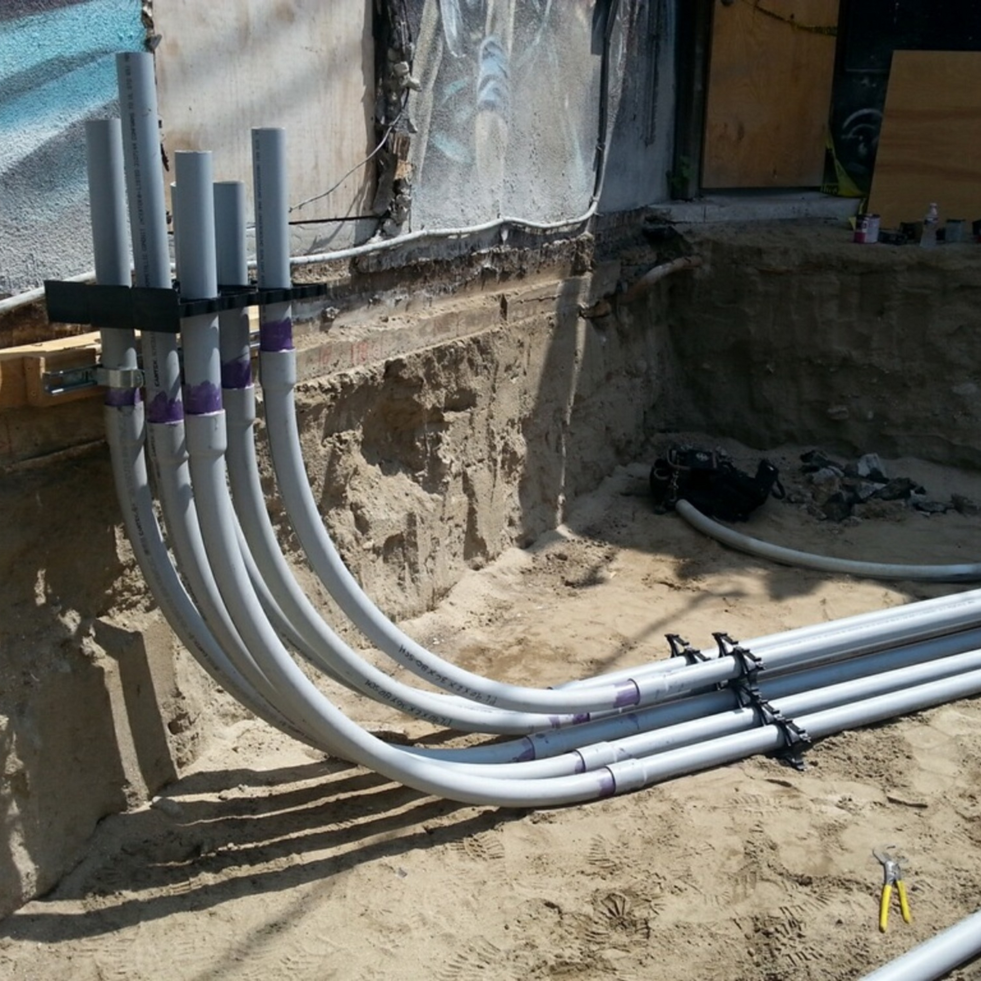 Michael Lawrence Electric Inc
-A bunch of white pipes are laying in the dirt