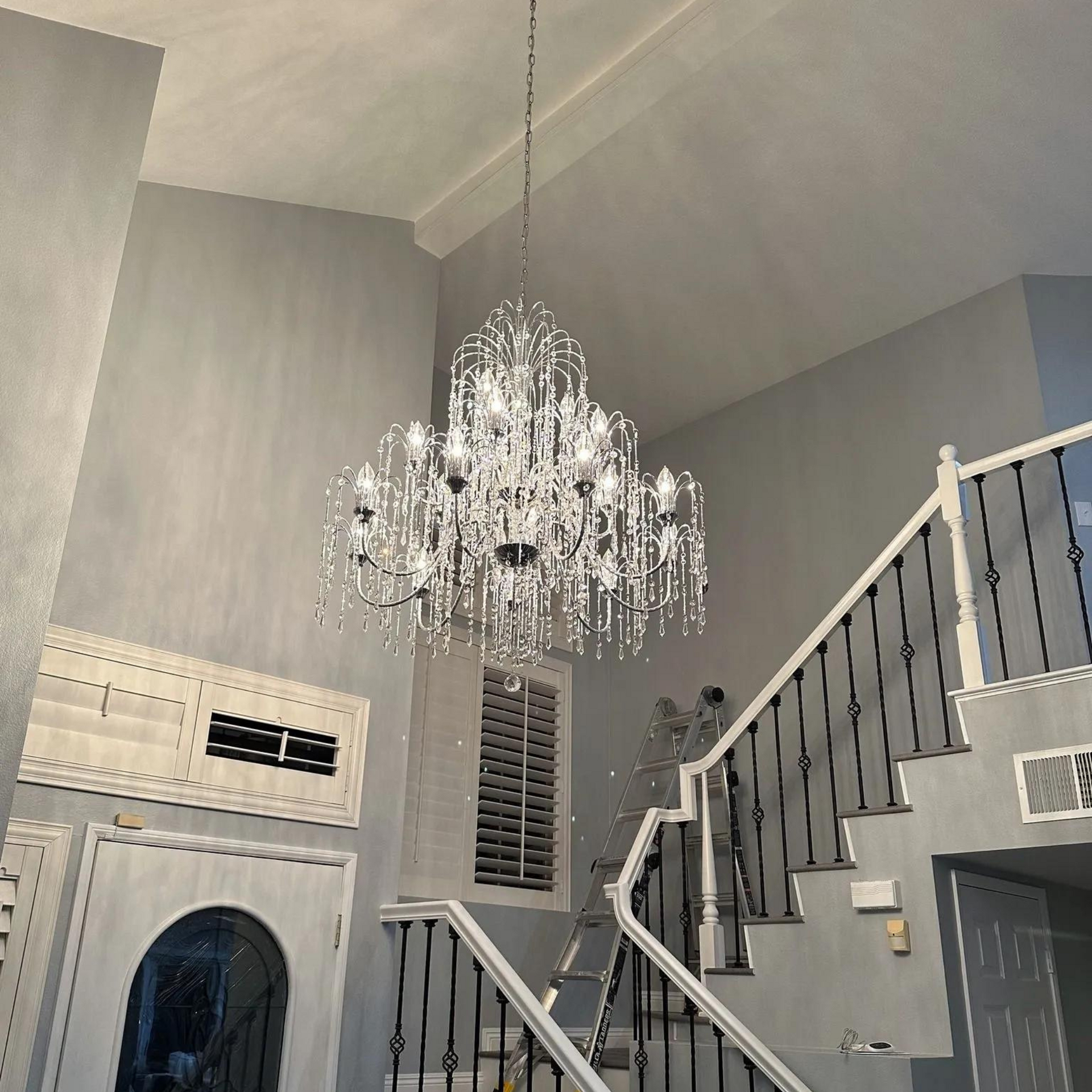 Michael Lawrence Electric Inc
- A staircase with a chandelier hanging from the ceiling