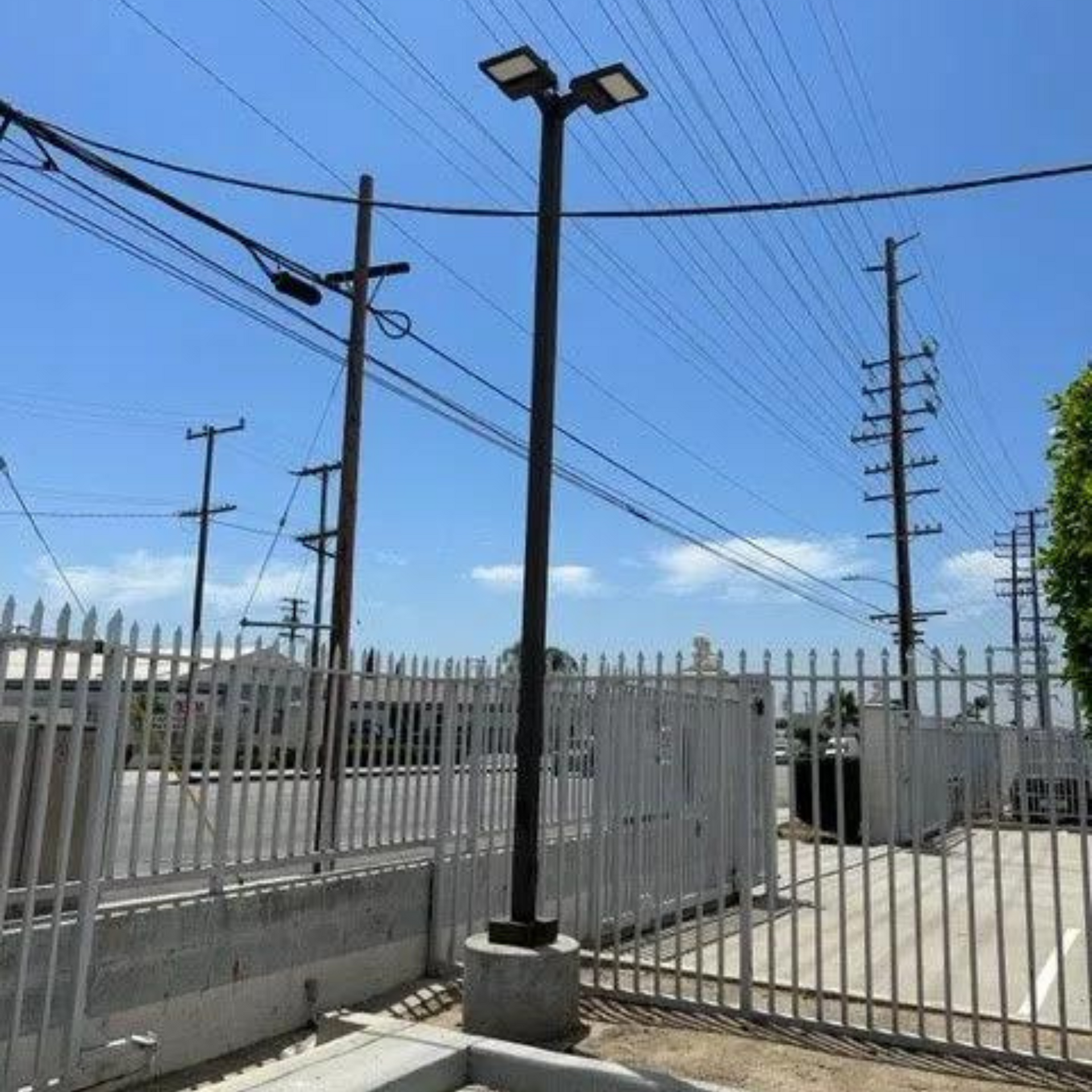 Michael Lawrence Electric Inc
- A fenced in area with power lines and a street light
