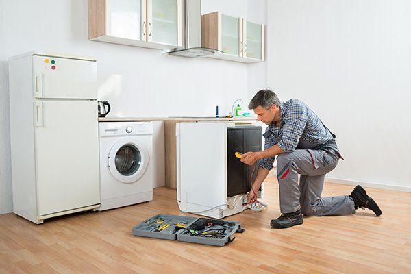 Technician Checking Dishwasher with Digital Multimeter — Lake Worth, FL — Maurice Appliance Service