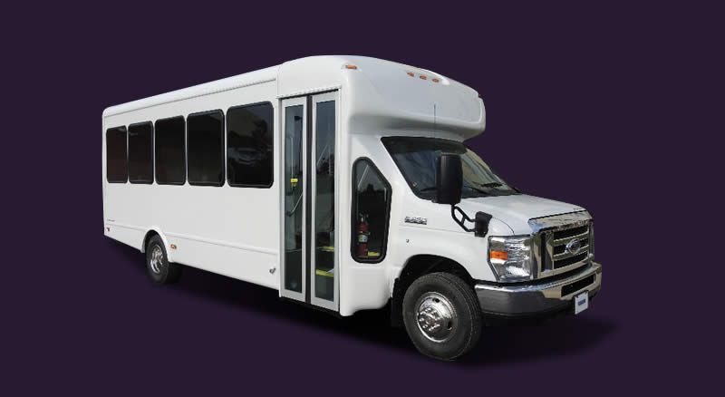 A white bus is parked on a purple background.