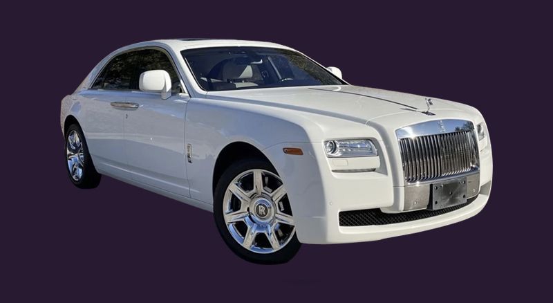 A white rolls royce ghost is shown on a purple background.