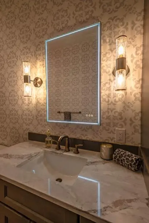 A bathroom with a sink and a mirror on the wall.