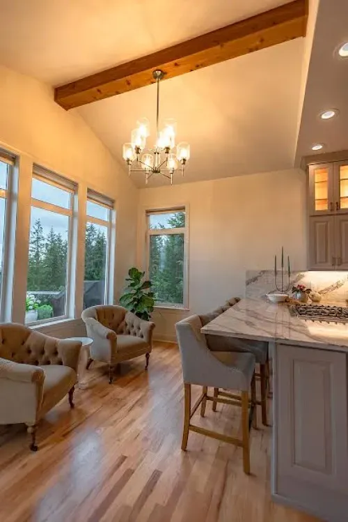 A living room with hardwood floors and a chandelier hanging from the ceiling.