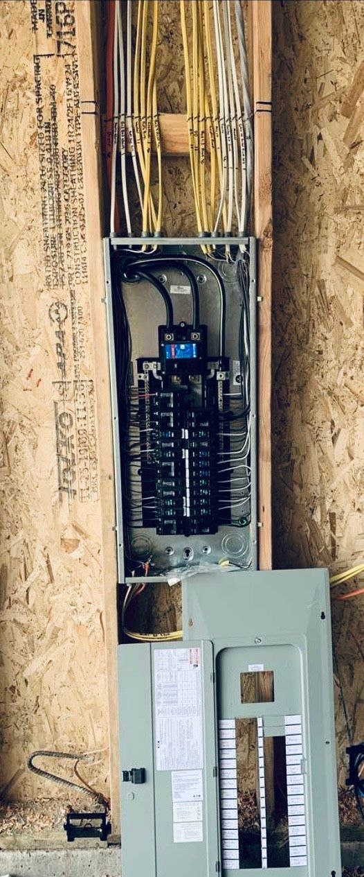 A electrical box is hanging on a wooden wall.