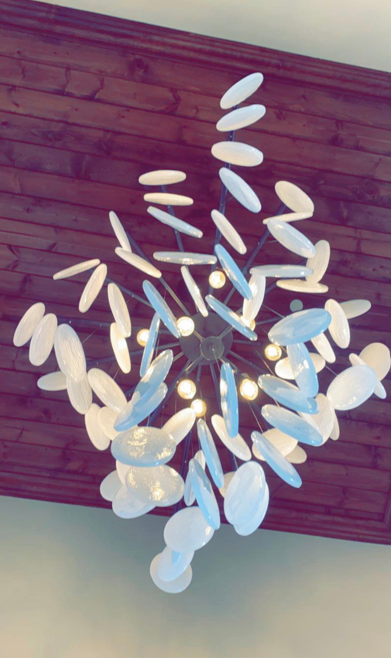 A chandelier with blue and white lights hanging from the ceiling