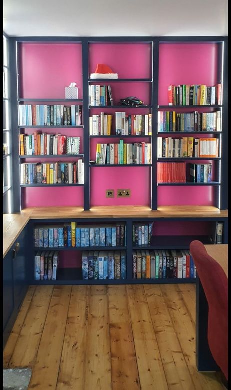 Pianted solid wood office
oak worktops
shelving
dark blue bookcase
blue and pink
lights