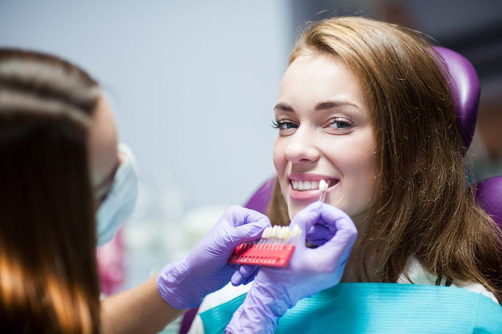 Orthodontist Checking Woman's Teeth