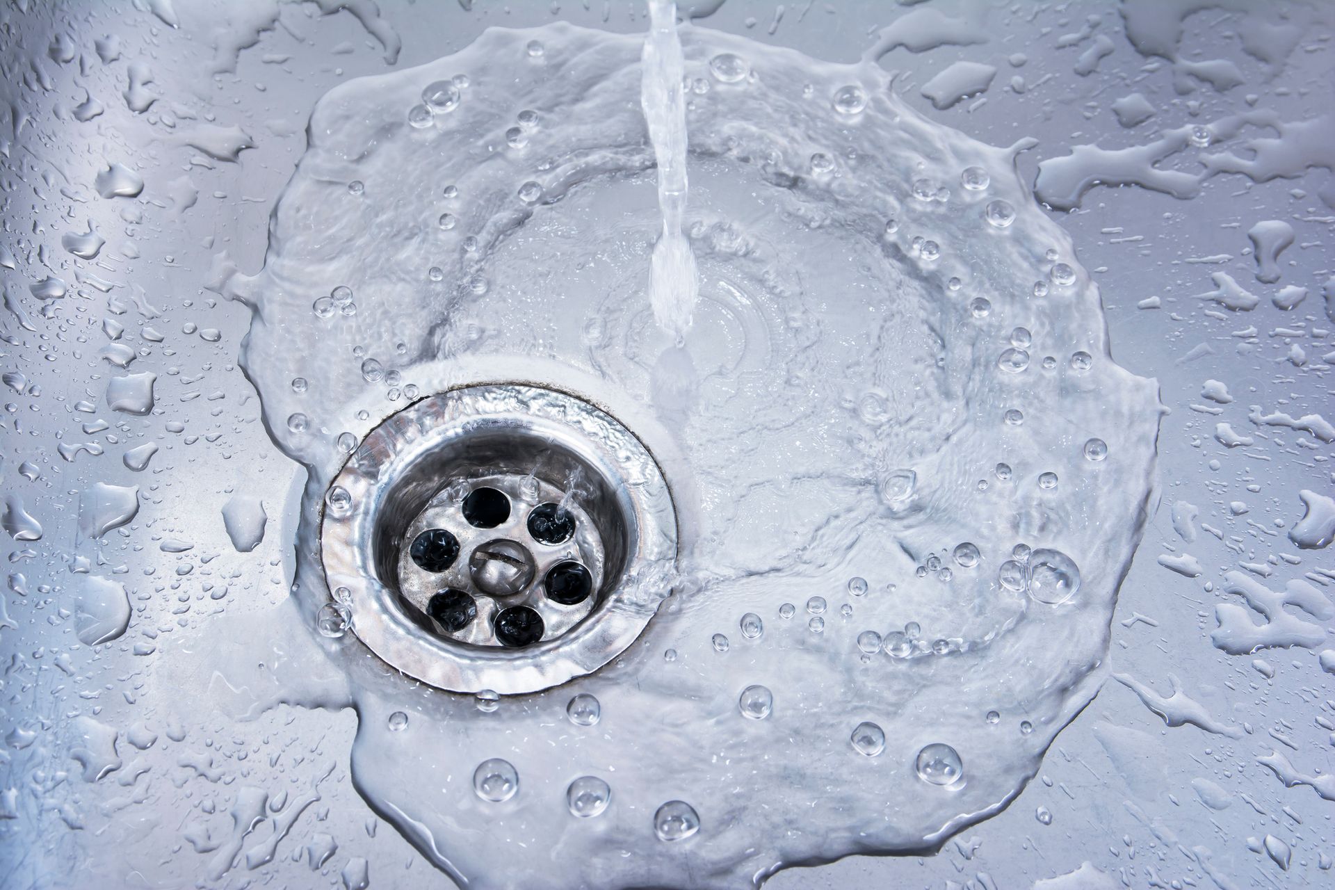 A Close Up of a Sink with Water Running Down the Drain — Albuquerque, NM — Al's Sewer Service