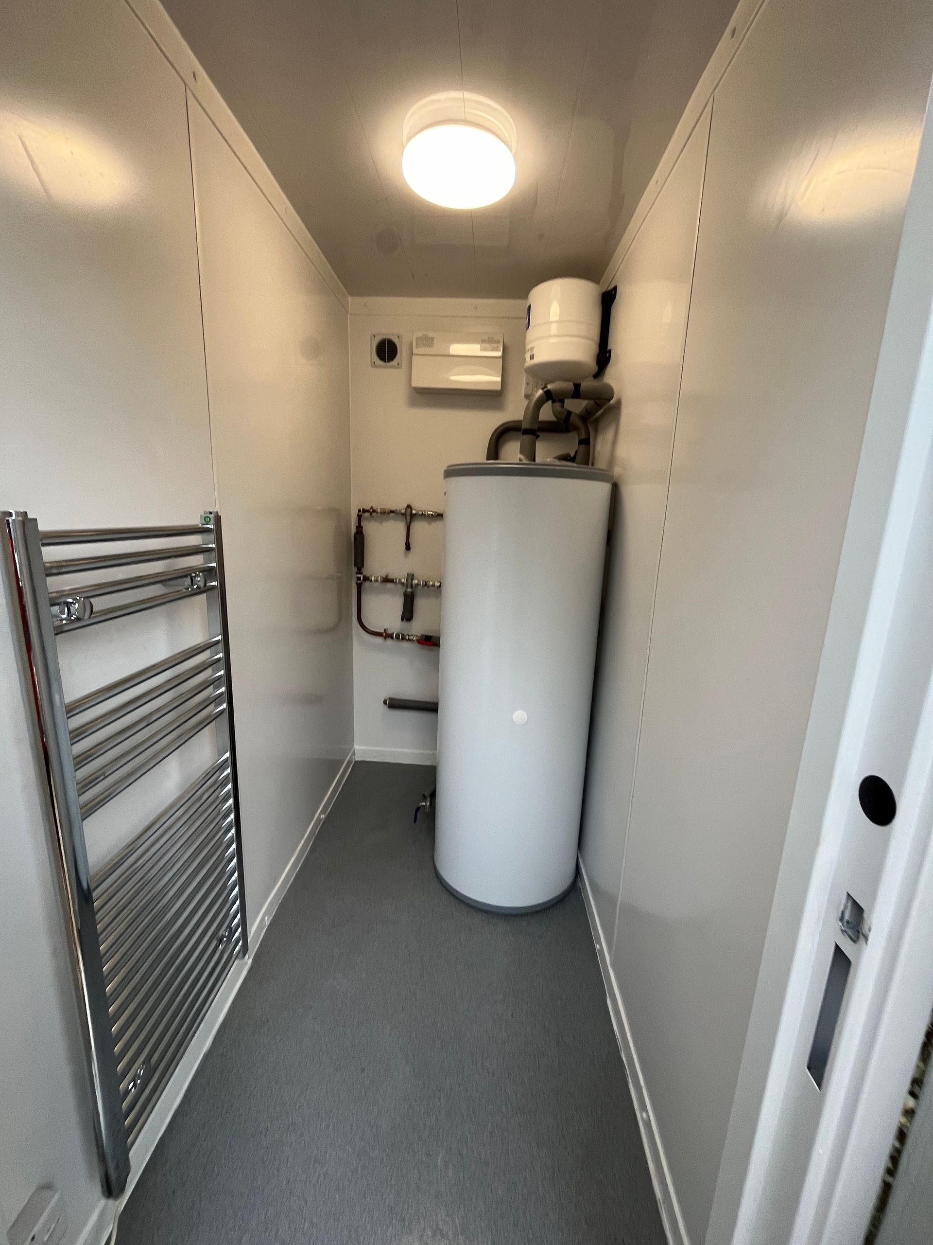 Plant room as part of a multi room shower and toilet block